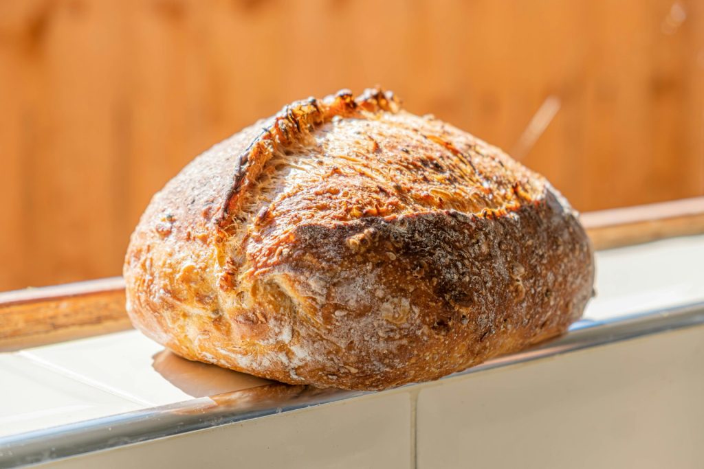 Round sourdough loaf with a floured, crackly crust