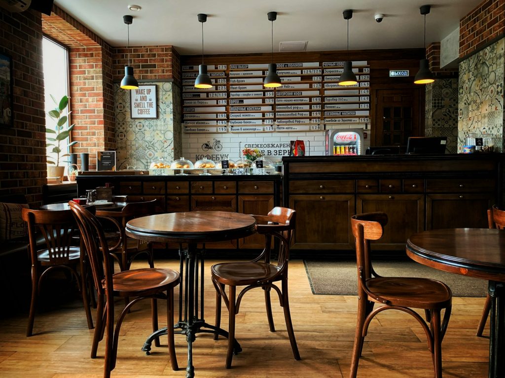 Warm café interior with brick walls and wooden tables